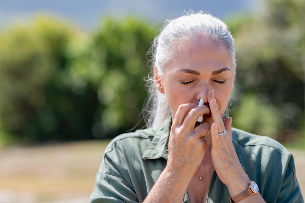 Yellowhead Cannabis Kamloops | Woman using nasal spray for allergy